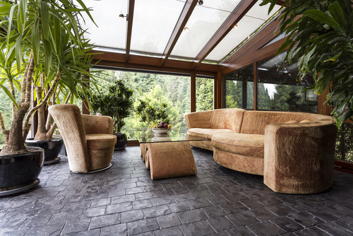 outside patio with stone floors, a sofa group and plants