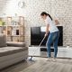 woman cleaning hard wood floor in a modern cozy living room